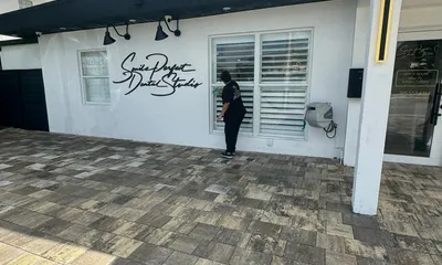 Ire Cleaning Services team member cleaning exterior windows of a Miami commercial office