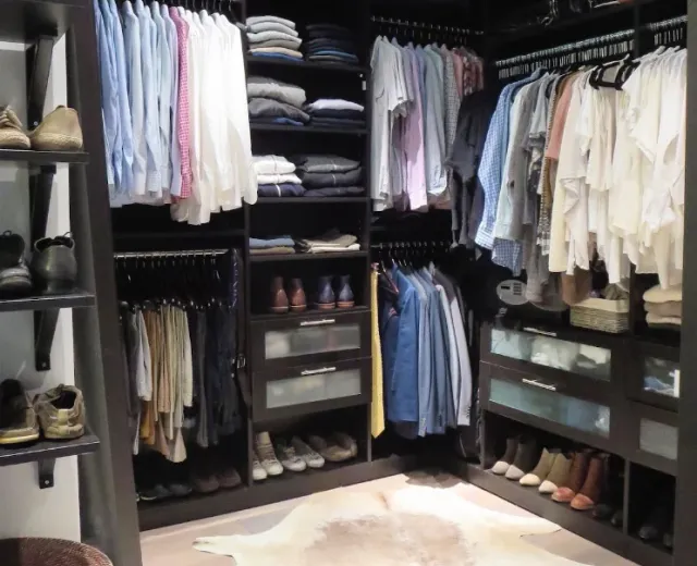 Neatly organized walk-in closet after an Ire Cleaning Services cleanout