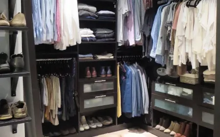 Neatly organized walk-in closet with folded clothes and paired shoes after an Ire Cleaning Services cleanout