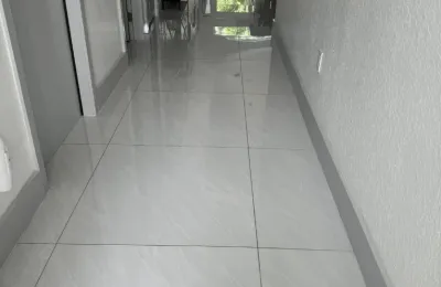 Mirror-polished tile hallway floor maintained through an Ire Cleaning Services recurring cleaning plan