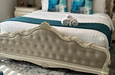 Staged Airbnb bedroom with hotel-style rolled towels after an Ire Cleaning Services turnover clean