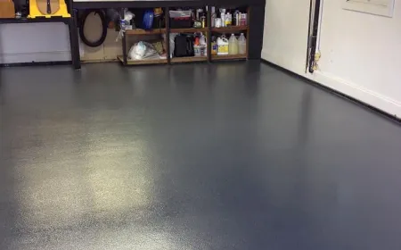Clean epoxy-coated garage floor with organized workbench after an Ire Cleaning Services garage cleaning