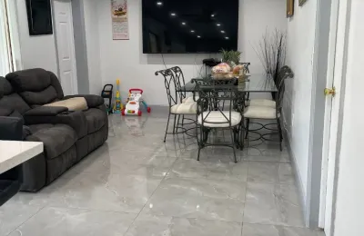Family living room with polished tile floors after an Ire Cleaning Services house cleaning
