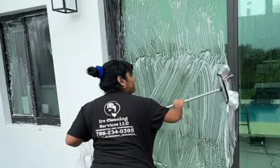 Ire Cleaning Services team member cleaning a glass door near our Sweetwater home base